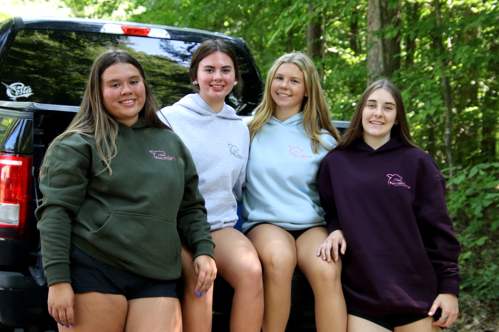 Friends hanging out in No Antlers Required hoodies